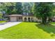 Charming single-story home with a well-maintained front yard and a driveway leading to an attached garage at 1105 Buckhurst Dr, Atlanta, GA 30349