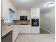 Efficient kitchen with white cabinets, a black dishwasher, and a microwave for modern conveniences at 1105 Buckhurst Dr, Atlanta, GA 30349