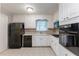 Functional kitchen with white cabinets, modern appliances, and a tile floor, designed for efficient meal preparation at 1105 Buckhurst Dr, Atlanta, GA 30349