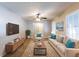 Bright living room featuring neutral walls, plush seating, a ceiling fan, and windows that flood the room with light at 1105 Buckhurst Dr, Atlanta, GA 30349