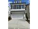 Charming two-story home featuring white siding, black shutters, and a convenient two-car garage at 1250 Winterhaven Dr, Cumming, GA 30041