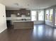 Open-concept kitchen with island, stainless steel appliances, and ample natural light at 1250 Winterhaven Dr, Cumming, GA 30041