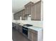 Modern kitchen featuring dark cabinetry, stainless steel appliances, and granite countertops at 1250 Winterhaven Dr, Cumming, GA 30041