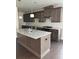 Modern kitchen featuring an island with granite counters, pendant lighting, and stainless steel appliances at 1250 Winterhaven Dr, Cumming, GA 30041