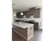 Modern kitchen featuring an island with granite counters, pendant lighting, and stainless steel appliances at 1250 Winterhaven Dr, Cumming, GA 30041