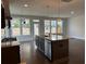 Open-concept kitchen with island, stainless steel appliances, and ample natural light at 1250 Winterhaven Dr, Cumming, GA 30041