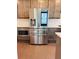 Stainless steel Samsung refrigerator with digital display and built-in ice and water dispenser at 1250 Winterhaven Dr, Cumming, GA 30041