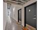 Apartment hallway with concrete floors, dark doors and industrial-style lighting at 195 Arizona Ne Ave # 199, Atlanta, GA 30307