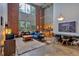 A bright living room with high ceilings and large windows looks into the kitchen and dining areas at 195 Arizona Ne Ave # 199, Atlanta, GA 30307