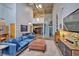 Comfortable living area with a large blue sofa, high ceilings, and a well-lit dining area at 195 Arizona Ne Ave # 199, Atlanta, GA 30307