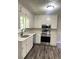 Well-lit kitchen featuring white cabinets, stainless steel appliances, and elegant countertops at 3800 Leisure Ln, Atlanta, GA 30349
