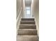 Carpeted stairway leads to the upper level of this home at 3800 Leisure Ln, Atlanta, GA 30349