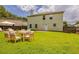 Spacious backyard with lush green grass, patio furniture, and a privacy fence for outdoor enjoyment and entertaining at 440 Pinevale Ct, Atlanta, GA 30349