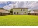 Large, grassy backyard with a wooden fence surrounding the property at 440 Pinevale Ct, Atlanta, GA 30349