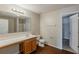 Bathroom with a vanity, toilet, mirror, and an open door that leads to a closet at 440 Pinevale Ct, Atlanta, GA 30349