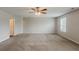 Spacious bedroom featuring neutral carpet, light-colored walls, and a ceiling fan at 440 Pinevale Ct, Atlanta, GA 30349