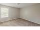 Bedroom with a neutral colored carpet and walls, a window and natural light at 440 Pinevale Ct, Atlanta, GA 30349