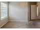 Bright bedroom with neutral walls and carpet and a window bringing in natural light at 440 Pinevale Ct, Atlanta, GA 30349