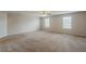 Large bedroom with neutral carpet, light-colored walls, and two windows at 440 Pinevale Ct, Atlanta, GA 30349