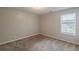 Bedroom with neutral walls and carpet and a window bringing in natural light at 440 Pinevale Ct, Atlanta, GA 30349