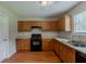 Functional kitchen with wood cabinets, essential appliances, and durable floors offering a practical cooking space at 440 Pinevale Ct, Atlanta, GA 30349