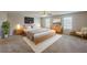Spacious main bedroom featuring a king bed, soft gray carpet, and windows providing natural light for a serene retreat at 440 Pinevale Ct, Atlanta, GA 30349