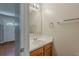This powder room features a wood vanity, white sink, framed mirror and neutral wall color at 440 Pinevale Ct, Atlanta, GA 30349