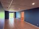 Spacious basement with tiled floor, bright blue walls, and recessed lighting at 133 Magazine St, Dallas, GA 30157