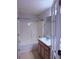 Full bathroom featuring a tub with shower, vanity, and a mirrored medicine cabinet at 133 Magazine St, Dallas, GA 30157