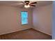 Bedroom with neutral walls, carpet, a window, and ceiling fan with lighting at 133 Magazine St, Dallas, GA 30157