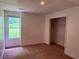 Bedroom with neutral walls, carpet, a window, and a closet at 133 Magazine St, Dallas, GA 30157