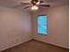 Bedroom with neutral walls, carpet, a window, and ceiling fan with lighting at 133 Magazine St, Dallas, GA 30157