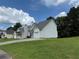 View of a single-Gathering home with a well-maintained lawn and a driveway, framed against a clear blue sky with clouds at 133 Magazine St, Dallas, GA 30157