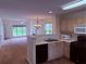The kitchen overlooks the living room, with black appliances, wood cabinets, and wood-look flooring at 133 Magazine St, Dallas, GA 30157