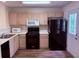 Well-equipped kitchen with black appliances, laminate countertops, and wood-look flooring at 133 Magazine St, Dallas, GA 30157