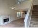 Bright living room featuring a marble fireplace, staircase and open-concept design to dining and kitchen at 133 Magazine St, Dallas, GA 30157