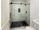 Modern bathroom with a glass-enclosed shower and black hardware at 243 Roxbury Dr, Riverdale, GA 30274