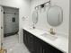 Bathroom featuring double vanity with quartz countertops, modern fixtures, and glass enclosed tile shower at 243 Roxbury Dr, Riverdale, GA 30274