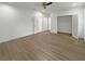 Spacious bedroom with sleek wood floors, a ceiling fan, and white trim at 243 Roxbury Dr, Riverdale, GA 30274