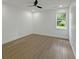 Bright bedroom features neutral colors, a ceiling fan, and a sunlit window at 243 Roxbury Dr, Riverdale, GA 30274