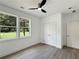 Well-lit bedroom with two windows, a ceiling fan, and a closet at 243 Roxbury Dr, Riverdale, GA 30274