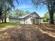 Exterior view of the back of the home, surrounded by trees at 243 Roxbury Dr, Riverdale, GA 30274