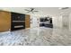 Modern living room with fireplace, stunning floors and views into the kitchen and dining areas at 243 Roxbury Dr, Riverdale, GA 30274