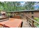 View of a back deck that features multiple seating areas and steps up to the home with a hot tub at 3229 Richwood Dr, Duluth, GA 30096