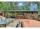 View of a back deck with multiple seating areas and steps leading to the home at 3229 Richwood Dr, Duluth, GA 30096