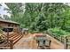 A tiered back deck with a hot tub, sitting area, with lush green backyard at 3229 Richwood Dr, Duluth, GA 30096