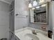 Cozy bathroom featuring a gray vanity, decorative mirror, and tub-shower with a colorful curtain at 3229 Richwood Dr, Duluth, GA 30096