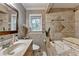 Bathroom featuring vanity with sink and toilet, as well as a tiled bath tub with shower at 3229 Richwood Dr, Duluth, GA 30096