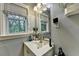 Bathroom with a single sink vanity, large mirror, and natural light from the window at 3229 Richwood Dr, Duluth, GA 30096
