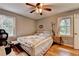 Bedroom features hardwood floors, two windows for natural light, and ceiling fan at 3229 Richwood Dr, Duluth, GA 30096